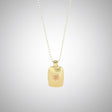 Jeffrey reimagined the classic dog tag into a modern canvas, both refined and a bit edgy. He loves mixing metals and embellished this 14k yellow gold dog tag with a contrasting 14K rose gold tiny flower charm