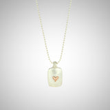 Jeffrey reimagined the classic dog tag into a modern canvas, both refined and a bit edgy. He loves mixing metals and embellished this sterling silver dog tag with a contrasting 14K rose gold tiny heart charm.