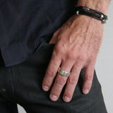 Jeffrey's double wrap leather bracelet is a modern and versatile streetwear accessory. The specially designed handcrafted sterling silver hook and eye clasp is reimagined from the old Roman style. The black leather wrap is embellished with 3 handcrafted sterling silver "donut" beads.