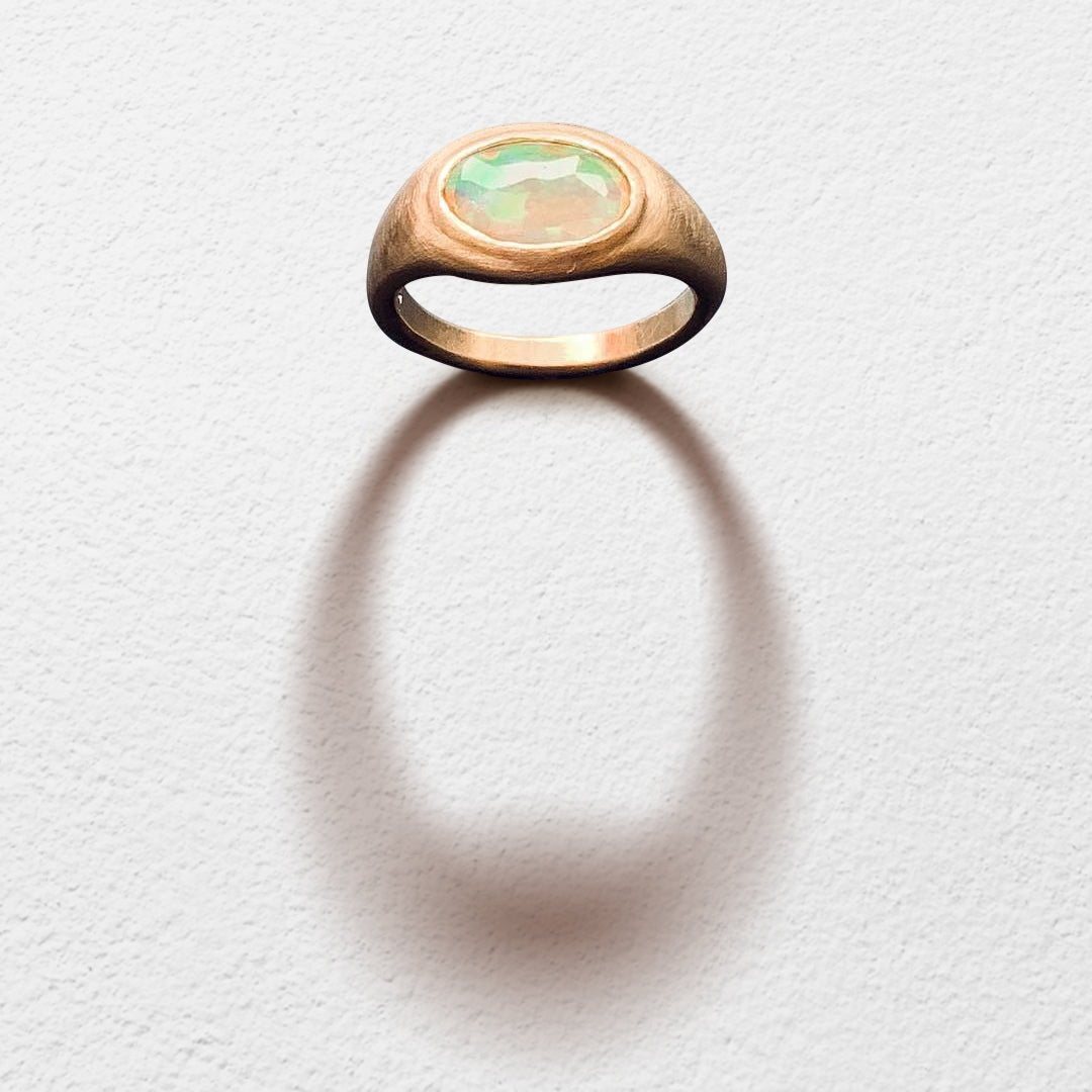 Poet and/the Bench goldsmith and co-founder Jeffrey Levin captured the beauty of this unique stone, hand-carving a yellow gold setting designed to bring the opal's best features to life. 