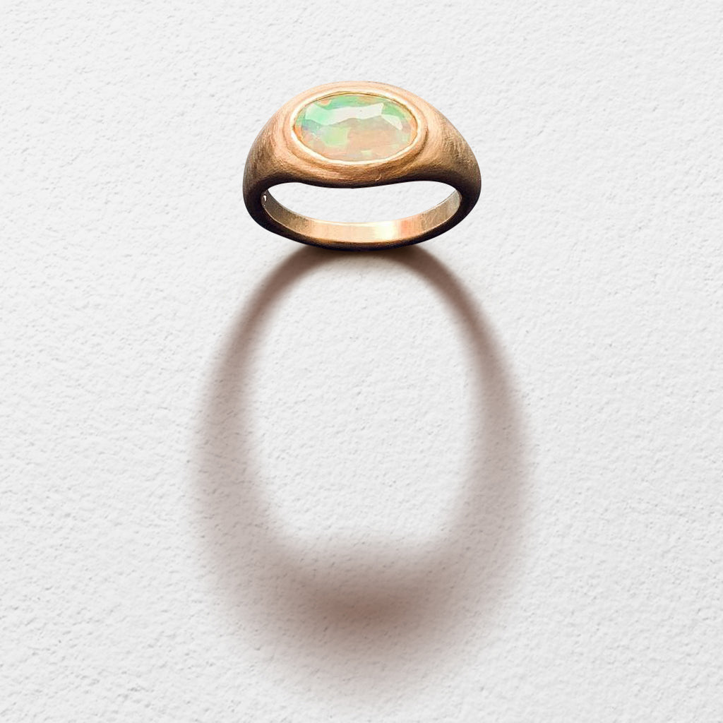 Poet and/the Bench goldsmith and co-founder Jeffrey Levin captured the beauty of this unique stone, hand-carving a yellow gold setting designed to bring the opal's best features to life. 