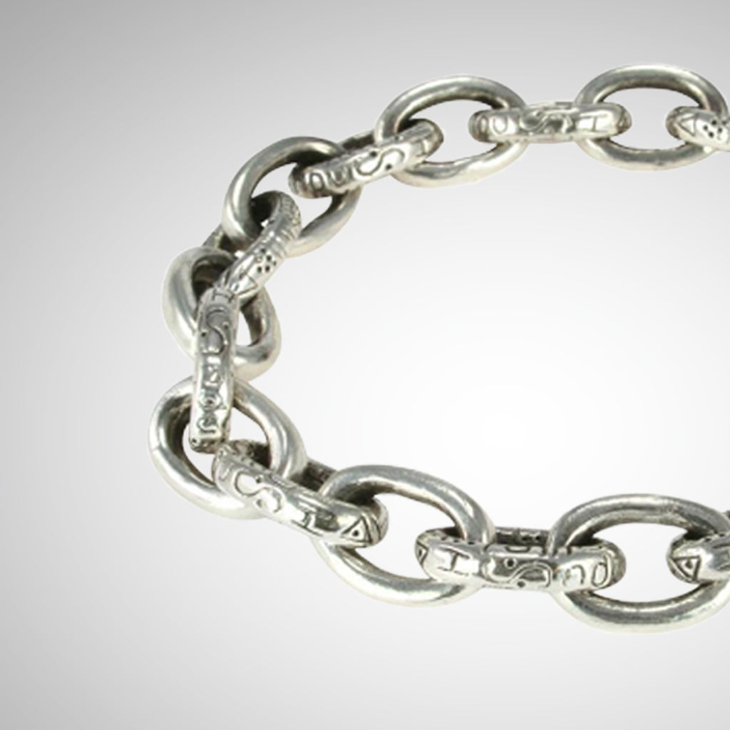 Designed and hand carved by Jeffrey Levin, Poet and/the Bench co-founder and goldsmith, this thick silver, oval chain link bracelet is yours to stack or stun on its own. The engraved oval links are finished with an architectural joint clasp system that seamlessly fit together. Edgy, yet timeless chain link jewelry.