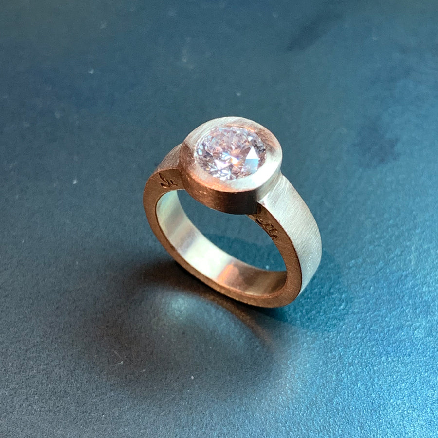 The custom engagement ring designed by Jeffrey Levin has been carved in wax, cast in rose gold and features and stunning diamond.
