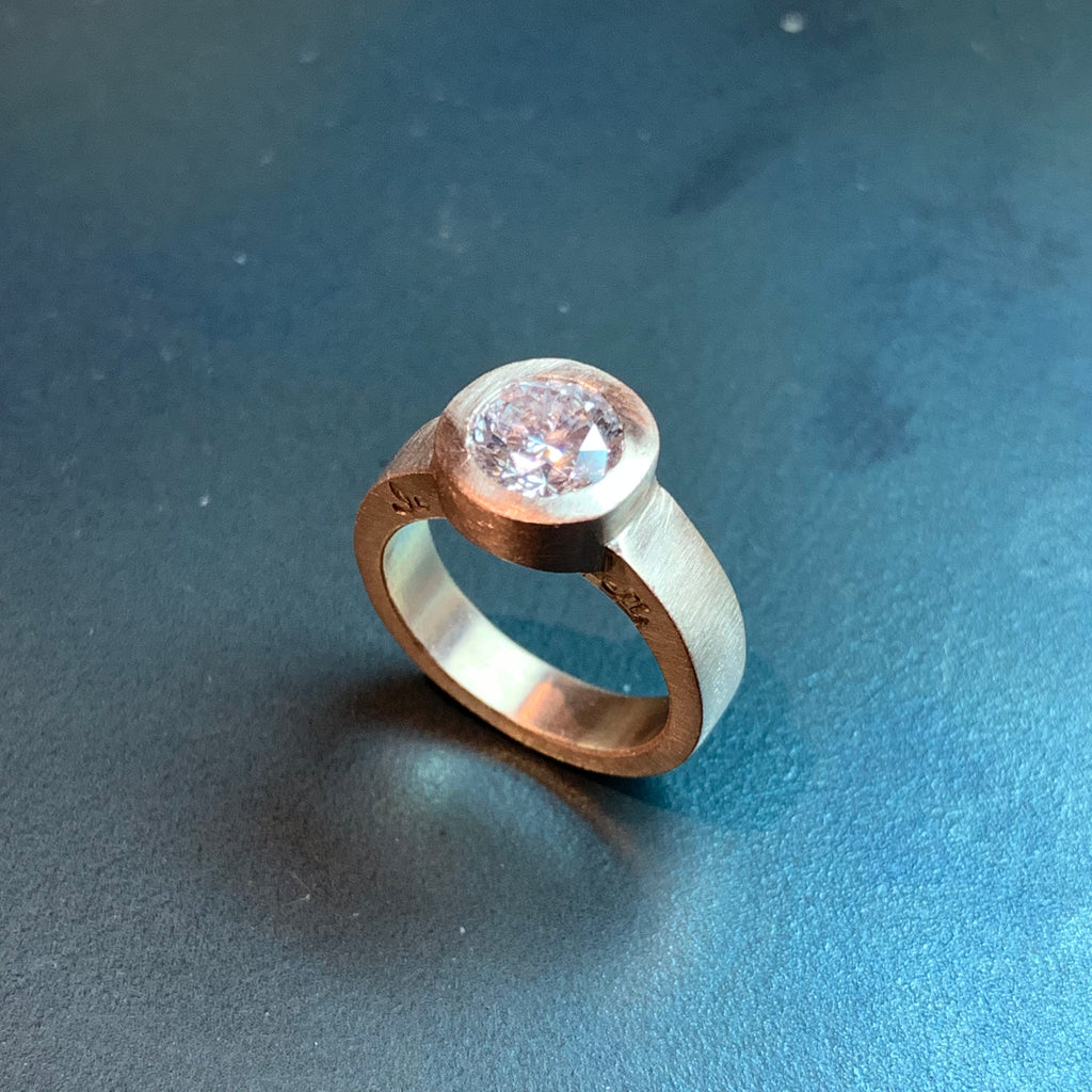 This design was created as a bespoke engagement ring by Poet and/the Bench co-founder and goldsmith Jeffrey Levin. Jeffrey's design specifically highlights the brilliant 1.25 carat diamond we sourced. 