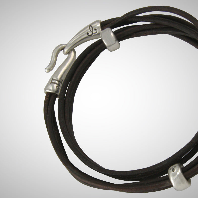 The specially designed handcrafted sterling silver hook and eye clasp  by designer Jeffrey Levin is reimagined from the old Roman style. The black leather wrap is embellished with 3 handcrafted sterling silver "donut" beads.