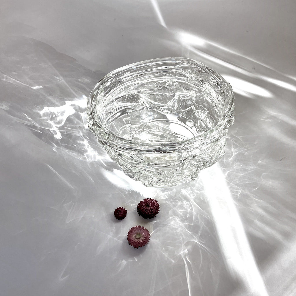 An extraordinary XL glass bowl that incorporates thick strands of glass in a wavy, Fluid design that captures and reflects light by artist Jennifer Morgan. top inside view