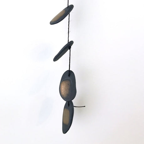 The Droplets is a hand built ceramic wall hanging with references to water, pebbles and other natural materials. The freeform shapes have a visceral quality, inspired by observations of landscape, the natural world, textiles, and metallic elements. 