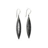 These bold earrings by Mariella Pilato are super light to wear. The parallel lines create a seeming illusion of solidity despite the open space within long earrings.