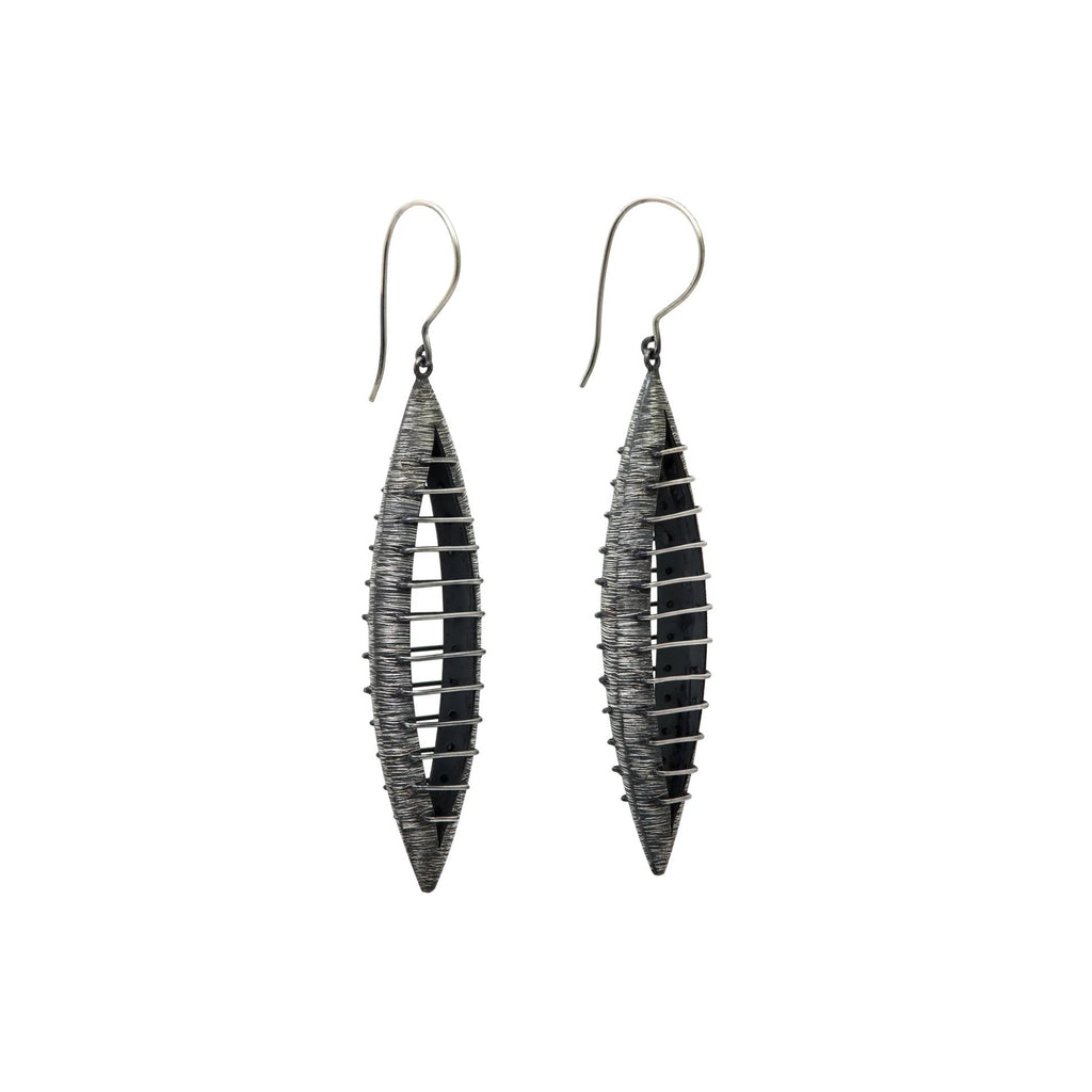 These bold earrings by Mariella Pilato are super light to wear. The parallel lines create a seeming illusion of solidity despite the open space within long earrings.