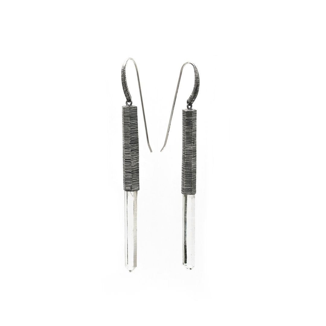 Subtle, elegant and streamlined bold. Mariella's Wand earrings are designed using a crystal point embraced in etched silver, which captures the crystal point crested by a heron’s neck.