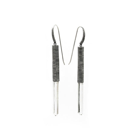 Subtle, elegant and streamlined bold. Mariella's Wand earrings are designed using a crystal point embraced in etched silver, which captures the crystal point crested by a heron’s neck.