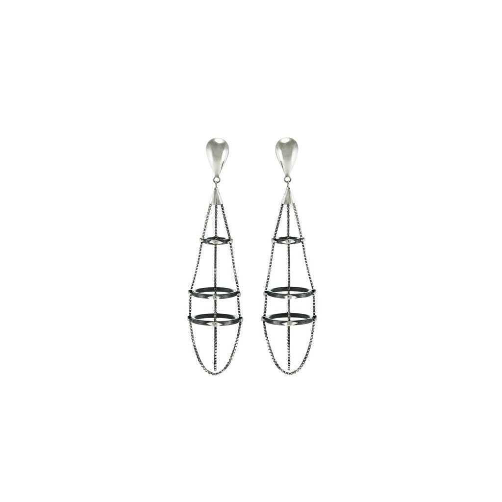 Stunning construction that exists in a space where the industrial and artistic meet. Mariella Pilato designed these light weight earrings inspired by a spider's web. 