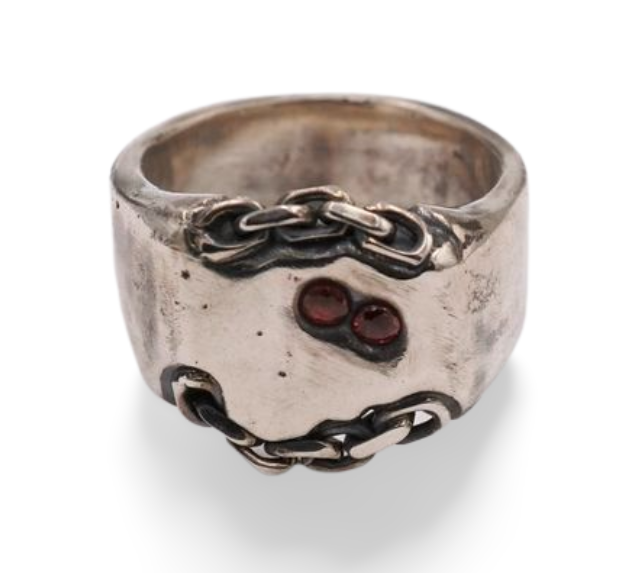 A sterling silver signet ring made from hand poured molten silver that is sand cast in a mould with sterling silver chain links for added texture and dimension adorned with red sapphires. 
