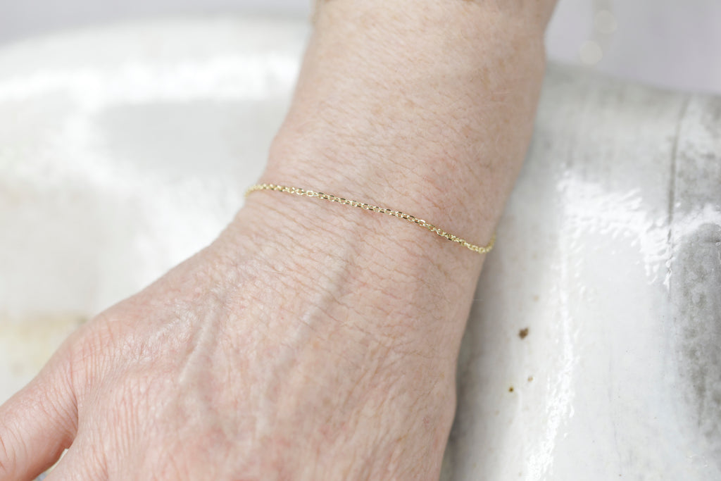 Permanent Jewelry Diamond Cut Cable Chain Link Bracelet shown on Bonnie's hand. Get Linked at Poet and/the Bench in Mill Valley. Together Permanent Jewelry for a Special Link to Yourself and Others at Poet and the Bench.