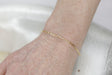 Permanent Jewelry Tiny Paperclip Chain Link Bracelet shown on Bonnie's hand. Get Linked at Poet and/the Bench in Mill Valley. 