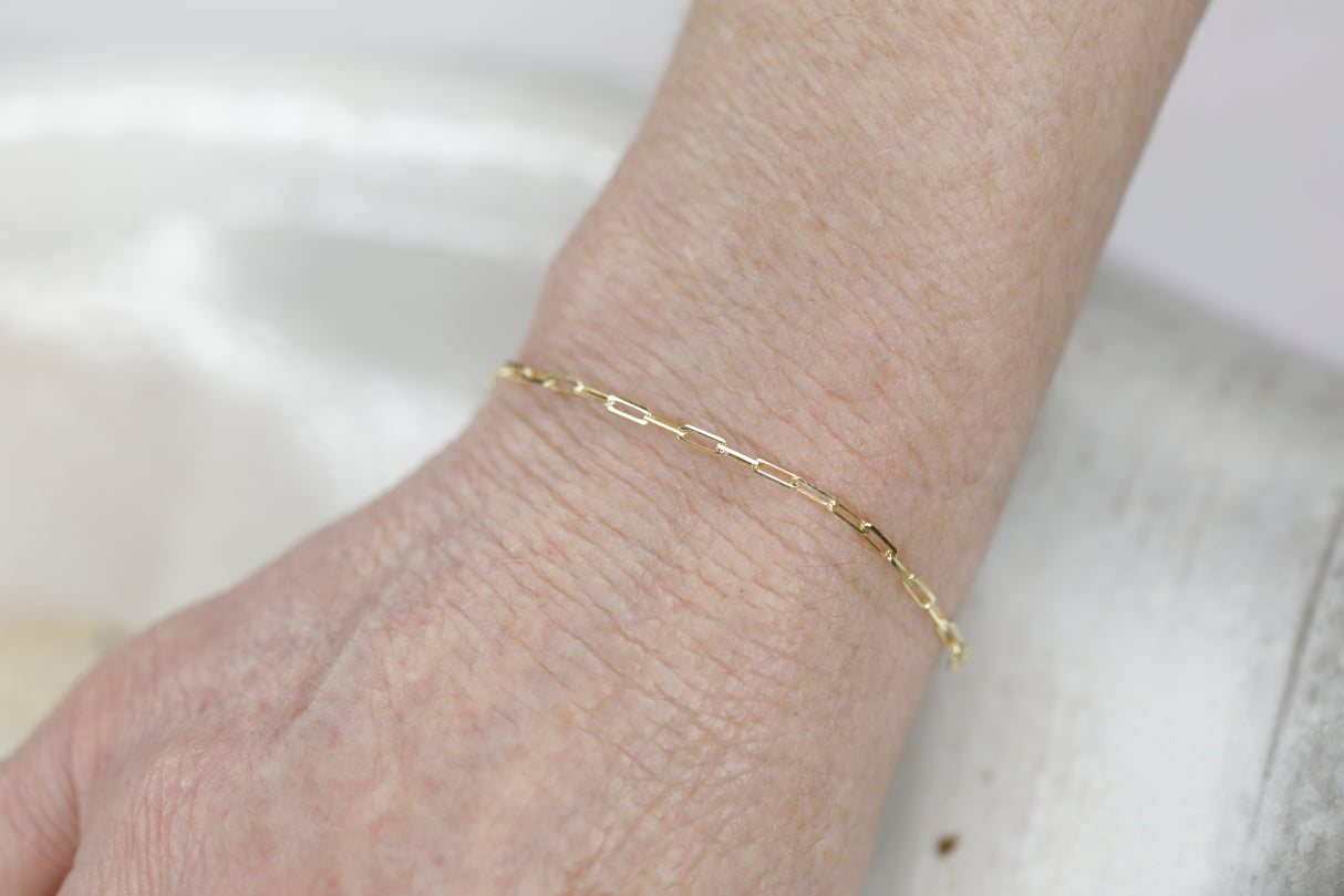 Permanent Jewelry Tiny Paperclip Chain Link Bracelet shown on Bonnie's hand. Get Linked at Poet and/the Bench in Mill Valley. 