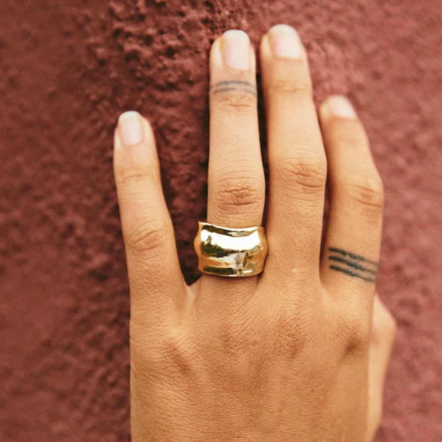 Organically shaped wide Brass Roam Vintage Orfeo Ring on model's hand