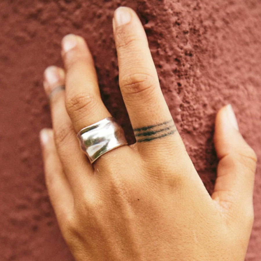 Organically shaped wide Sterling Silver Roam Vintage Orfeo Ring on model's hand