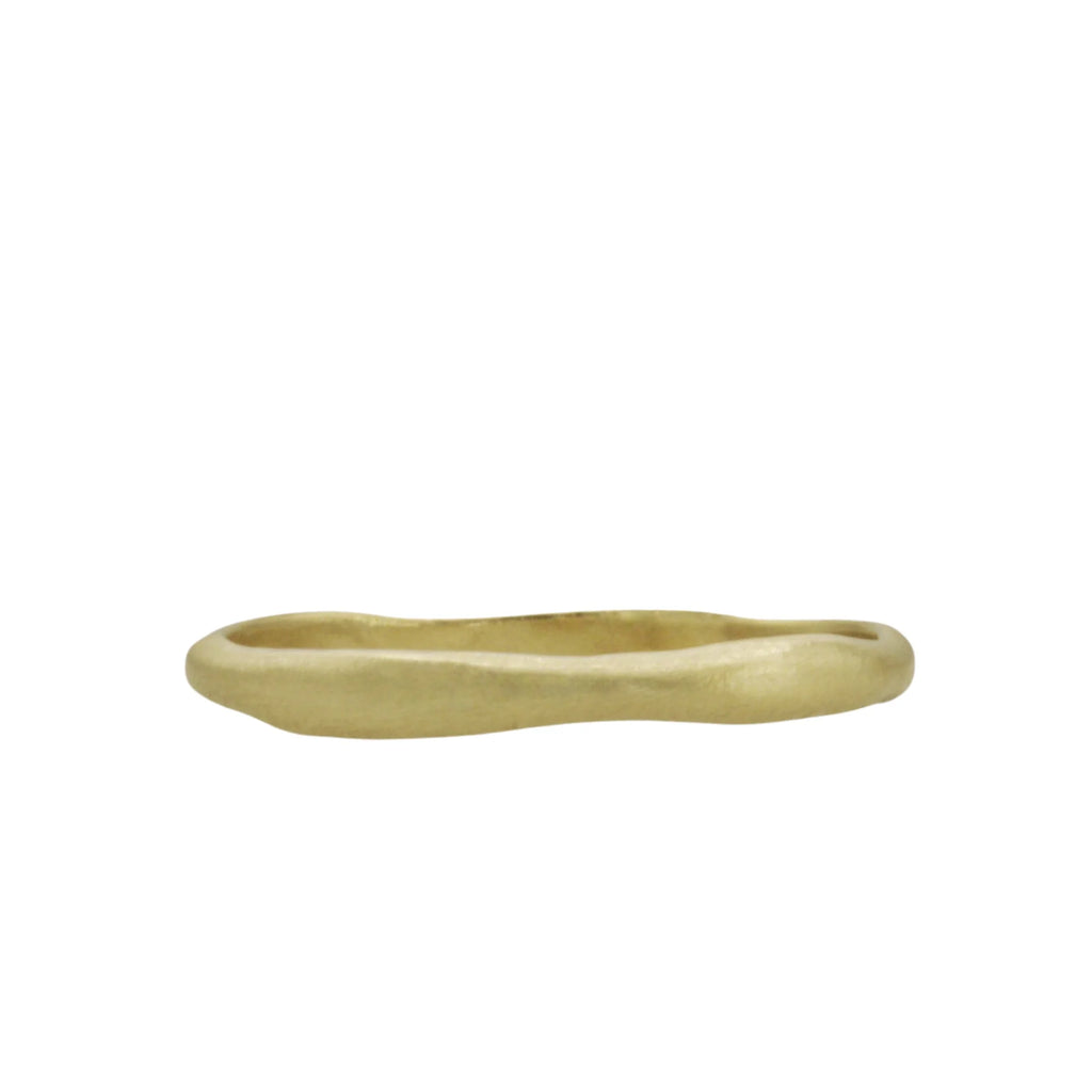 The Mare ring by Talking Tree Jewelry is a sculptural, curved 14K gold ring with an organic, ancient, undulating shape reminiscent of the sea.