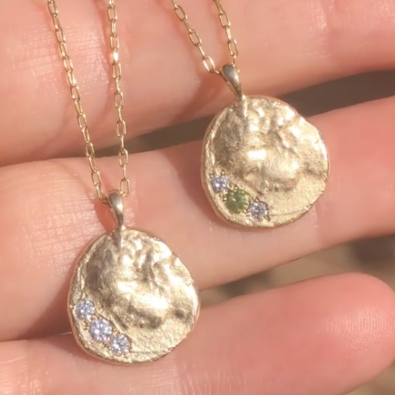Hand sculpted wearable artifacts by Talking Tree Jewelry are thoughtful heirlooms and an everyday talisman. The Metamorphoses Pendant with three grey diamonds was created to help you commemorate a special journey or life event. 