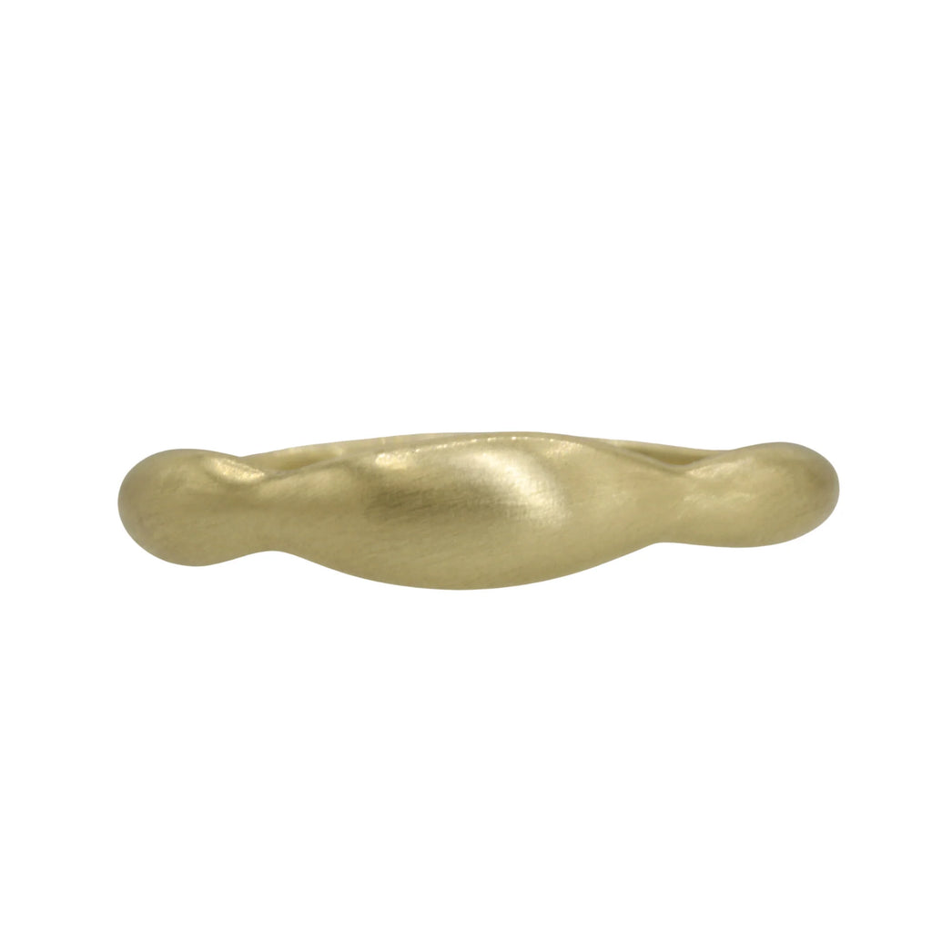 The Sirocco ring by Talking Tree Jewelry is a sculptural, curved 14K gold ring with undulating form. 