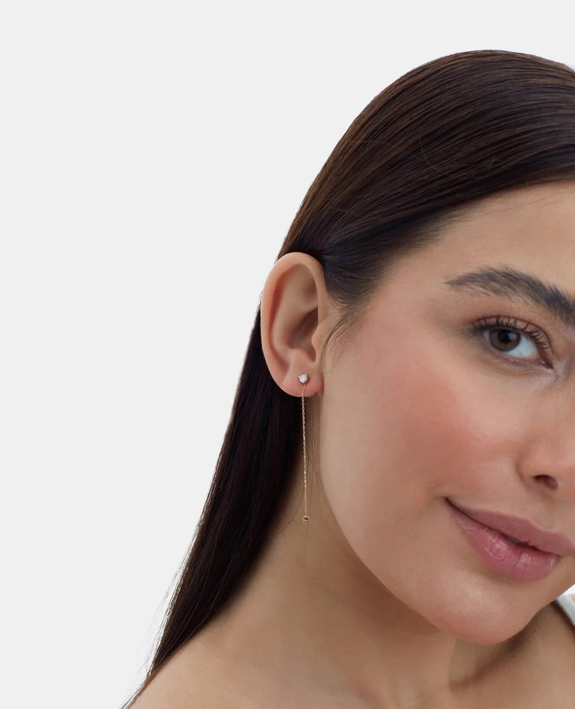 Elegant 14K gold studs feature 2 diamonds on each earring –one at the tip and one at the bottom of the chain– and 5.8mm of hanging chain that add extra dimension and a fierce style. On Model 