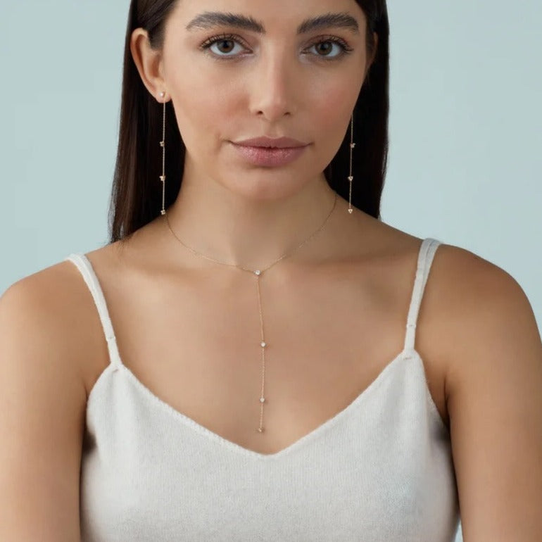 A gorgeous Y (aka lariat-style) necklace in 14K yellow gold, rose gold or white gold. 4 round white diamonds are suspended along the lustrous gold chain that dangles elegantly on your decolletage. Shown on model.