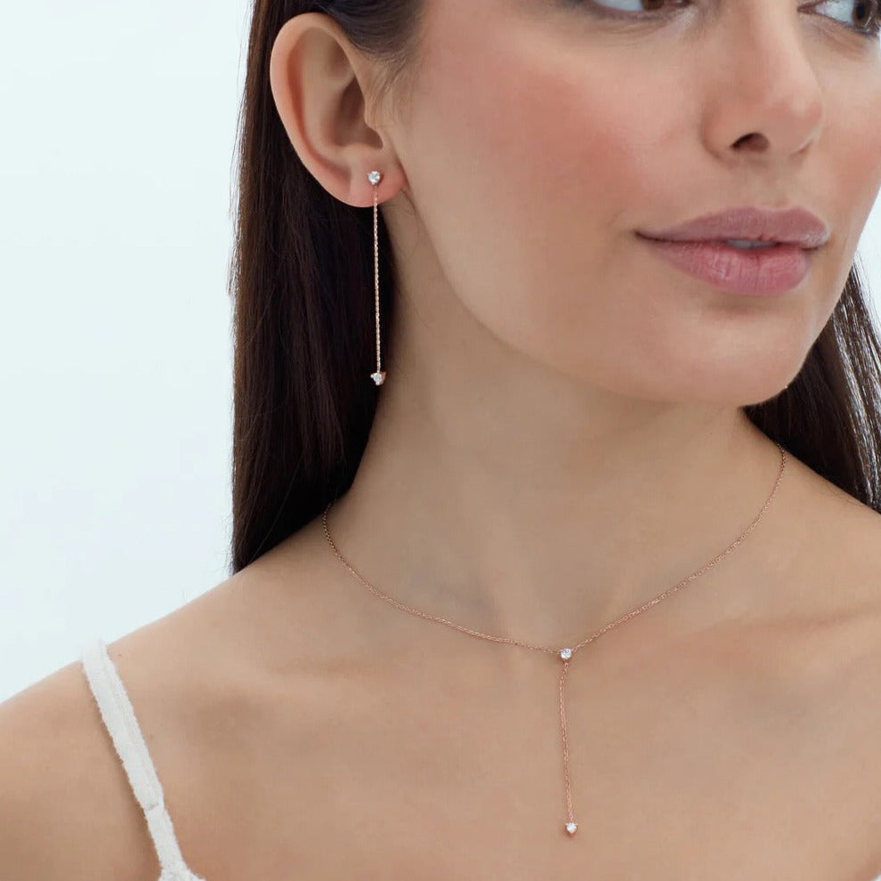 Betul Malik per diem 2 diamond y necklace and 2 diamond dangle earrings in 14k gold with 2 white ethically sourced diamonds. Shown on model
