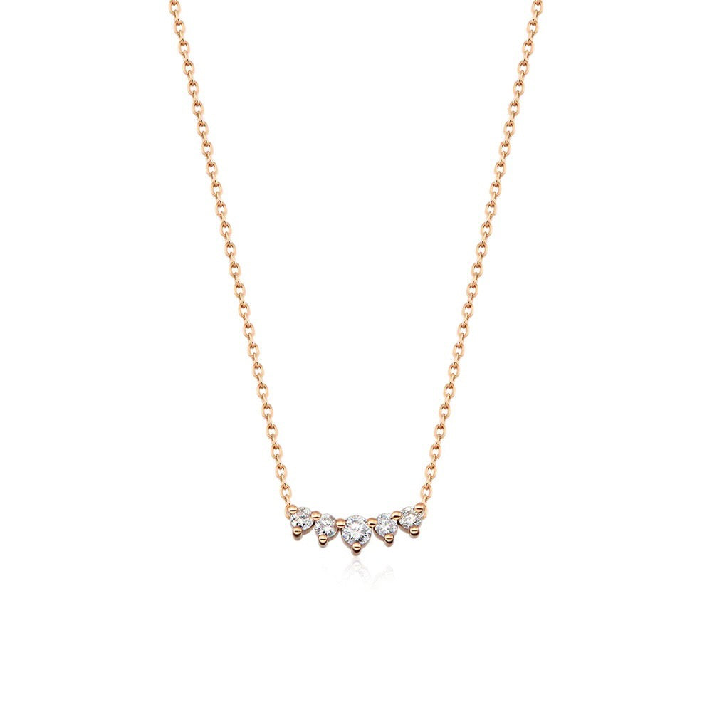 Five diamonds are clustered in a slightly curved bar in this elegant necklace paired with 14K yellow gold chain.