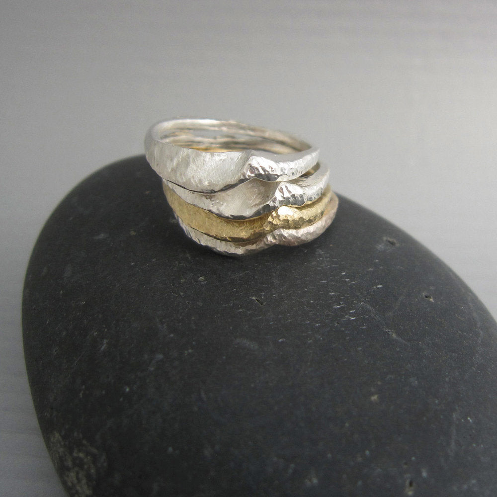 The wave ("onda" in Italian) ring by Maddalena Bearzi is beautiful to wear alone, but it creates elegant ocean swells when combined with other "onda" rings of the same or different metals. Shown in stack with other Onda rings in silver and bronze.