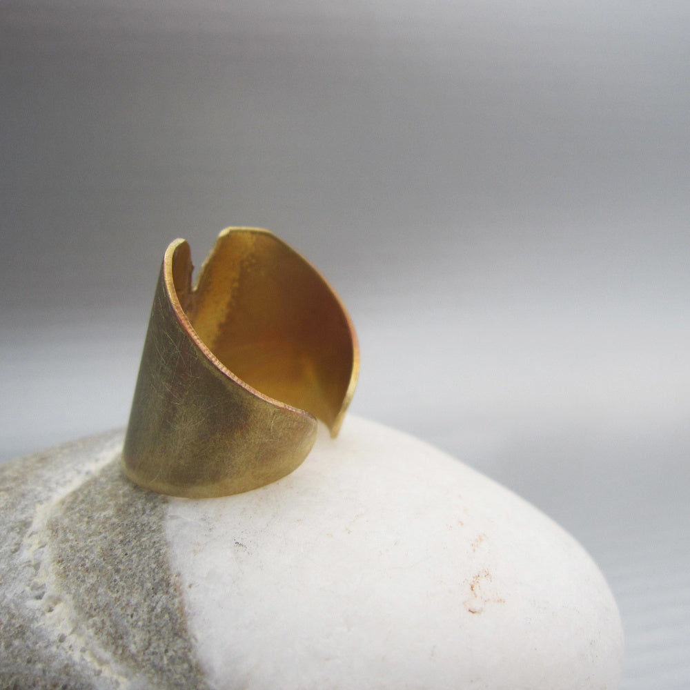 A little patch of golden earth is what inspired the creation of this unique and easy to wear band that makes a bold statement. Back of ring shown.